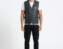 Men's black leather utility vest featuring multiple storage pockets, a zipper closure, and adjustable side straps.