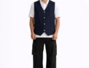 Men's black denim vest featuring a classic 4-snap front, reinforced shoulders, and a sleek sleeveless biker design.