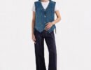 Women's blue denim utility vest with adjustable side laces, four front pockets, and a patch-ready back panel.